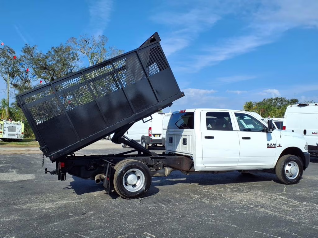 A landscape dump truck and a bucket truck side by side