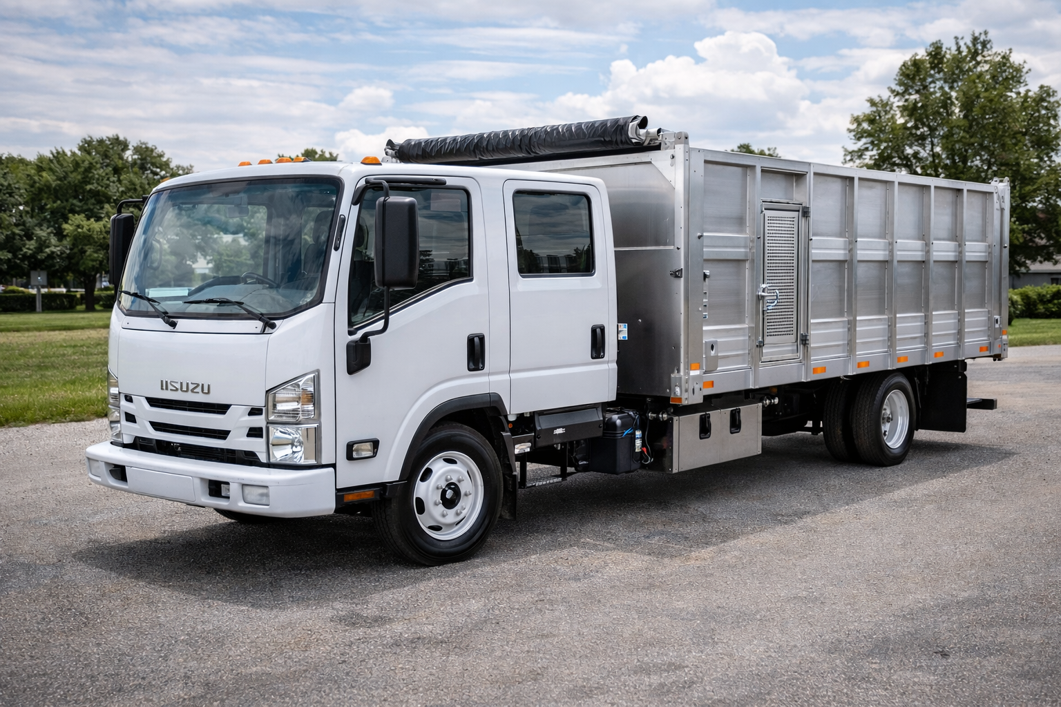 White Isuzu commercial truck with a metal waste hauling container.