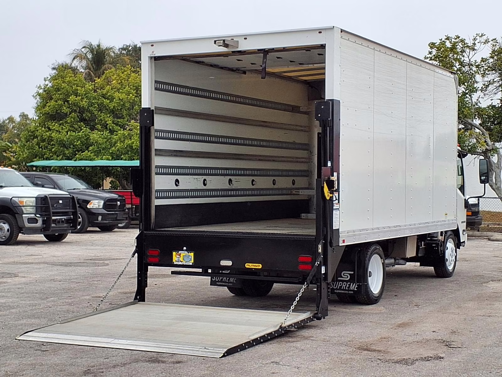 A commercial box truck liftgate in the middle of a smooth deployment test.