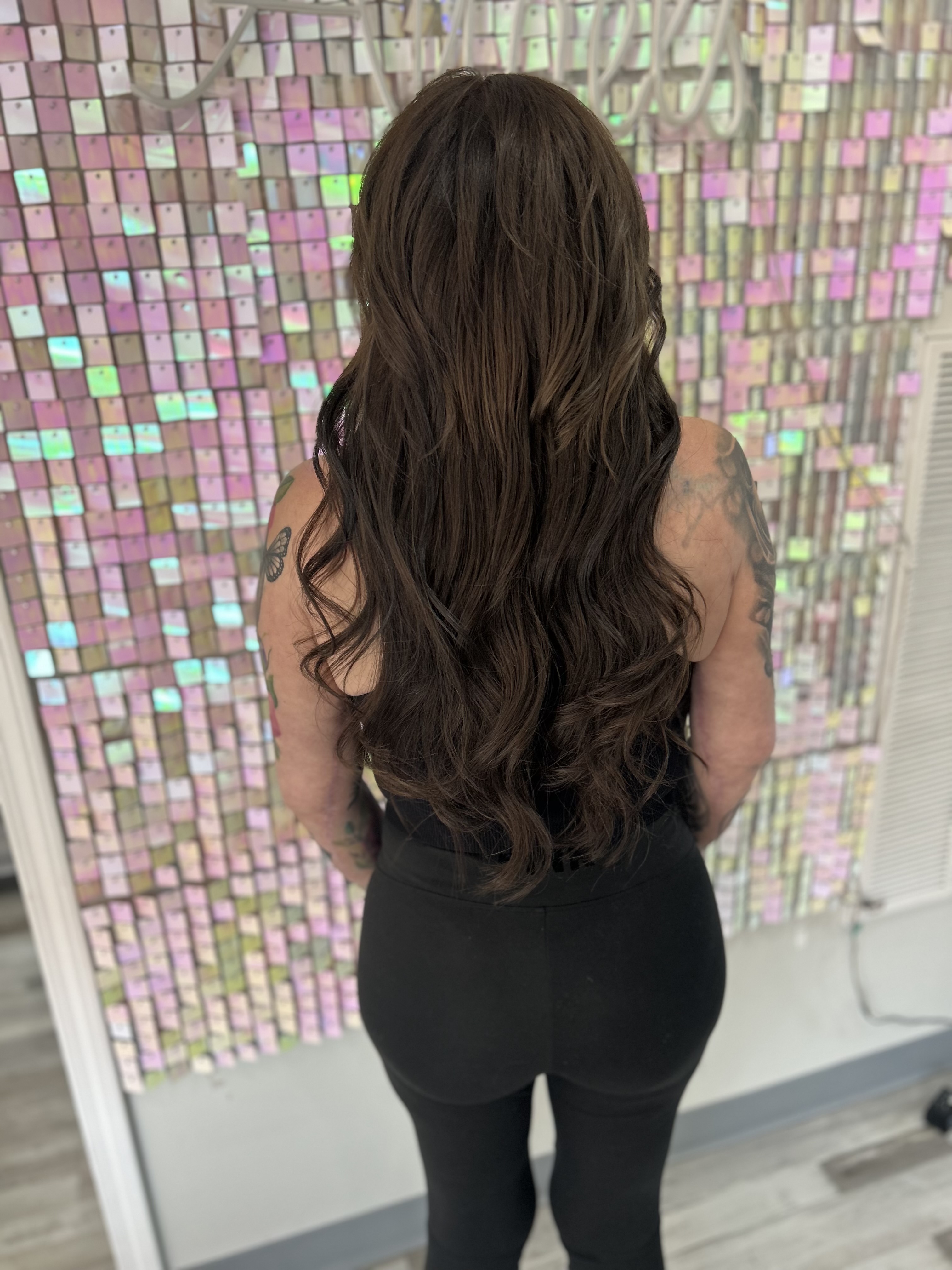 a woman wearing full cuticle hair extensions