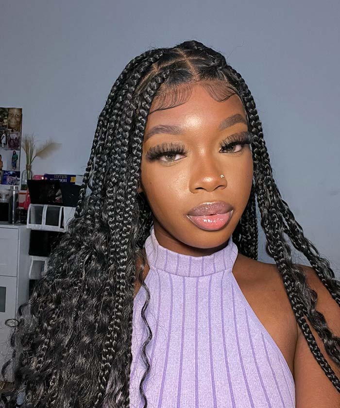 Sincerely4u – Box braids with curly ends on a stylish African-American woman in a black top.