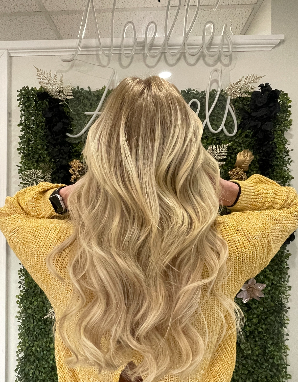 a woman wearing hand tied hair extensions with wavy hair