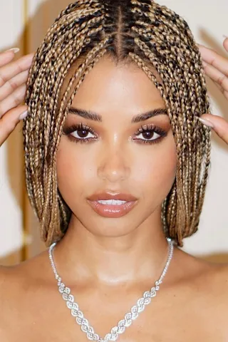A black woman wearing sincerely4u's Blonde Box Braids