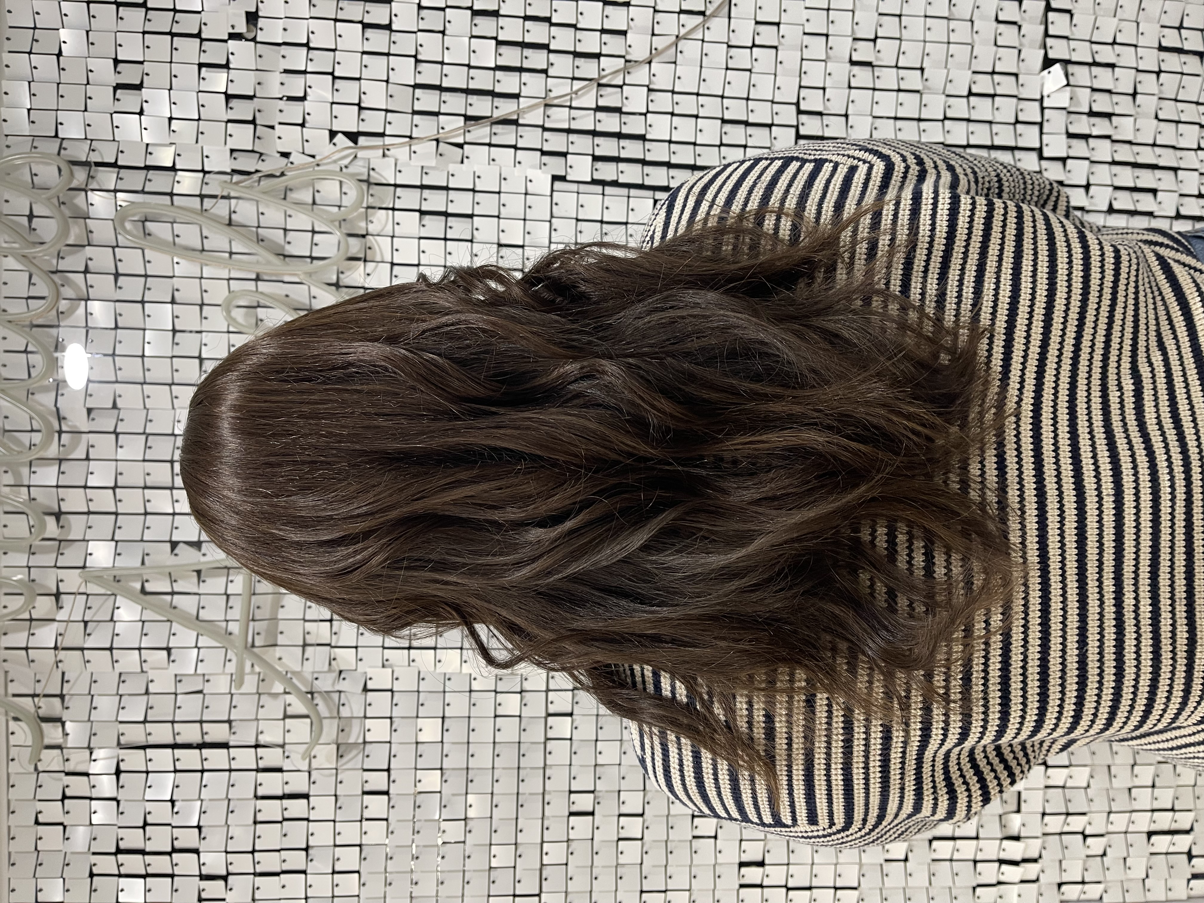 a woman wearing a micro bead hair topper for trichotillomania