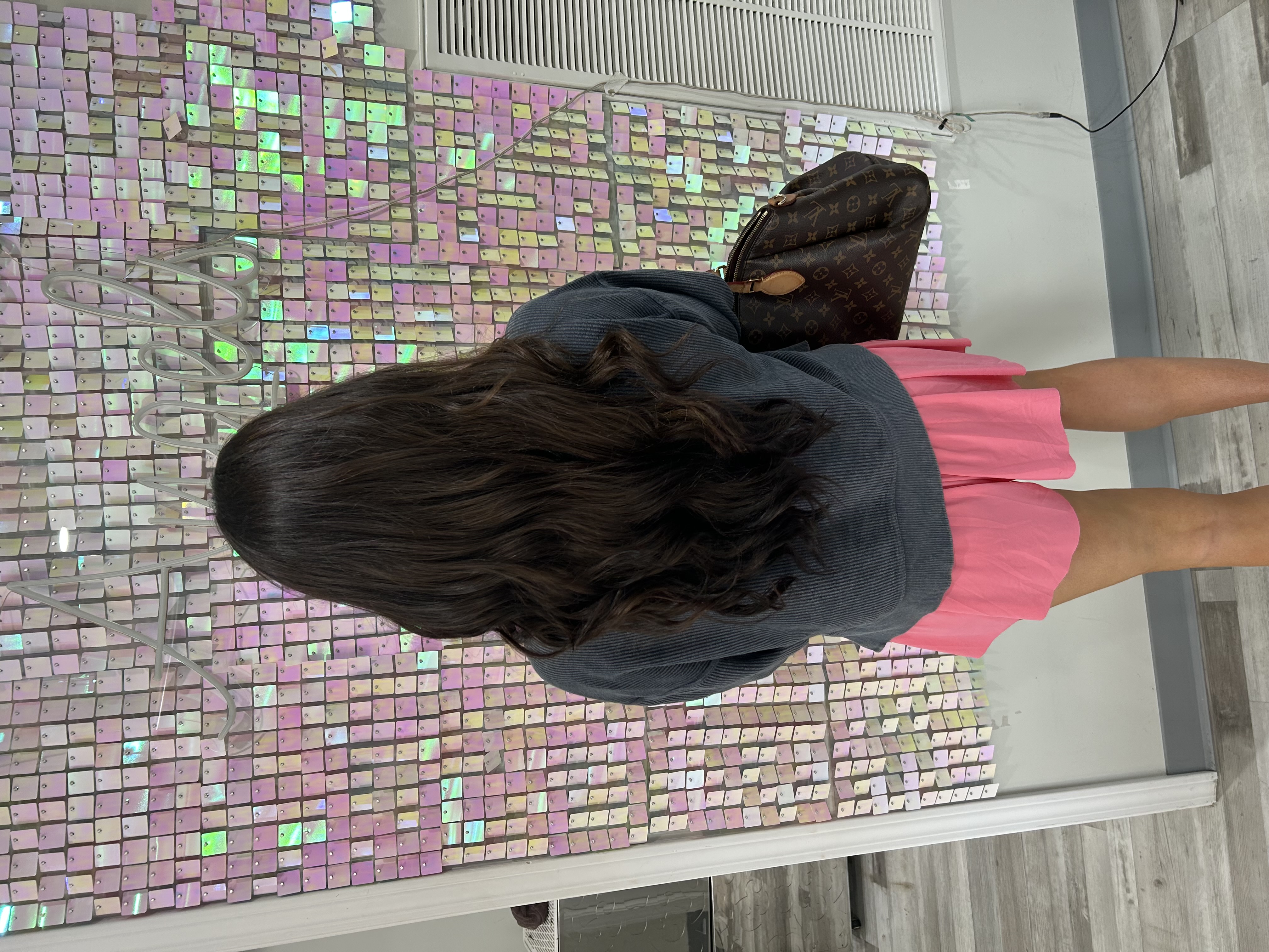 a woman with hair extensions kept healthy with K18 hair care