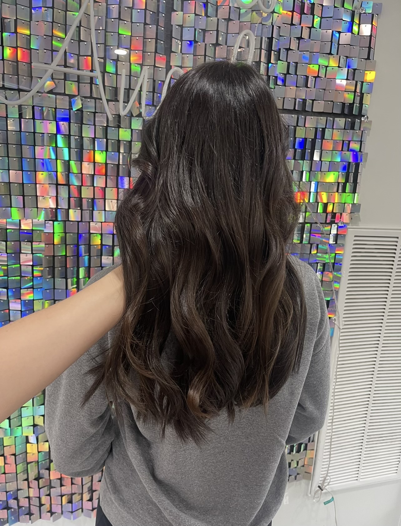 a woman wearing dark beaded weft hair extensions