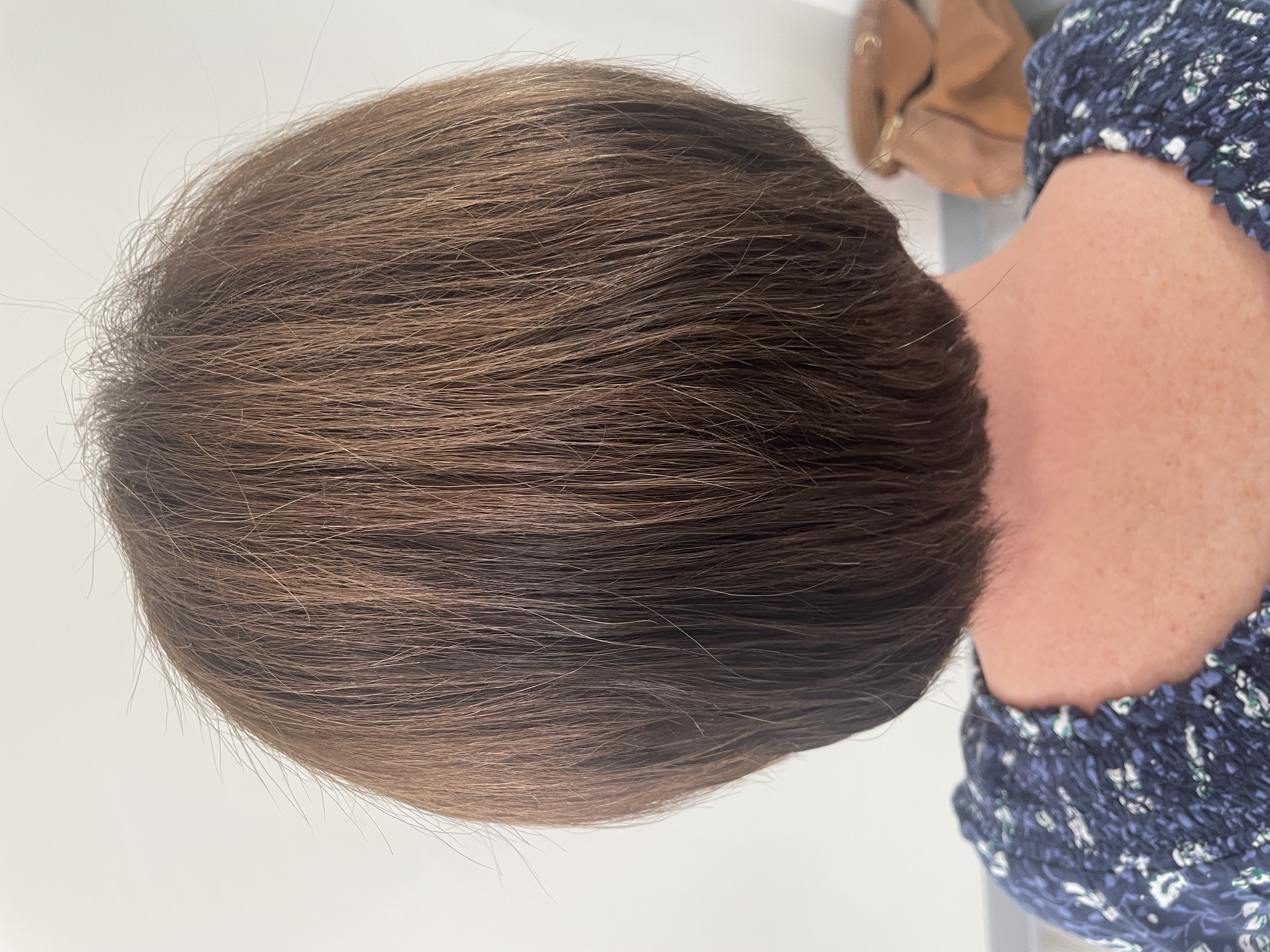 a custom mesh integration hair system in a bob haircut