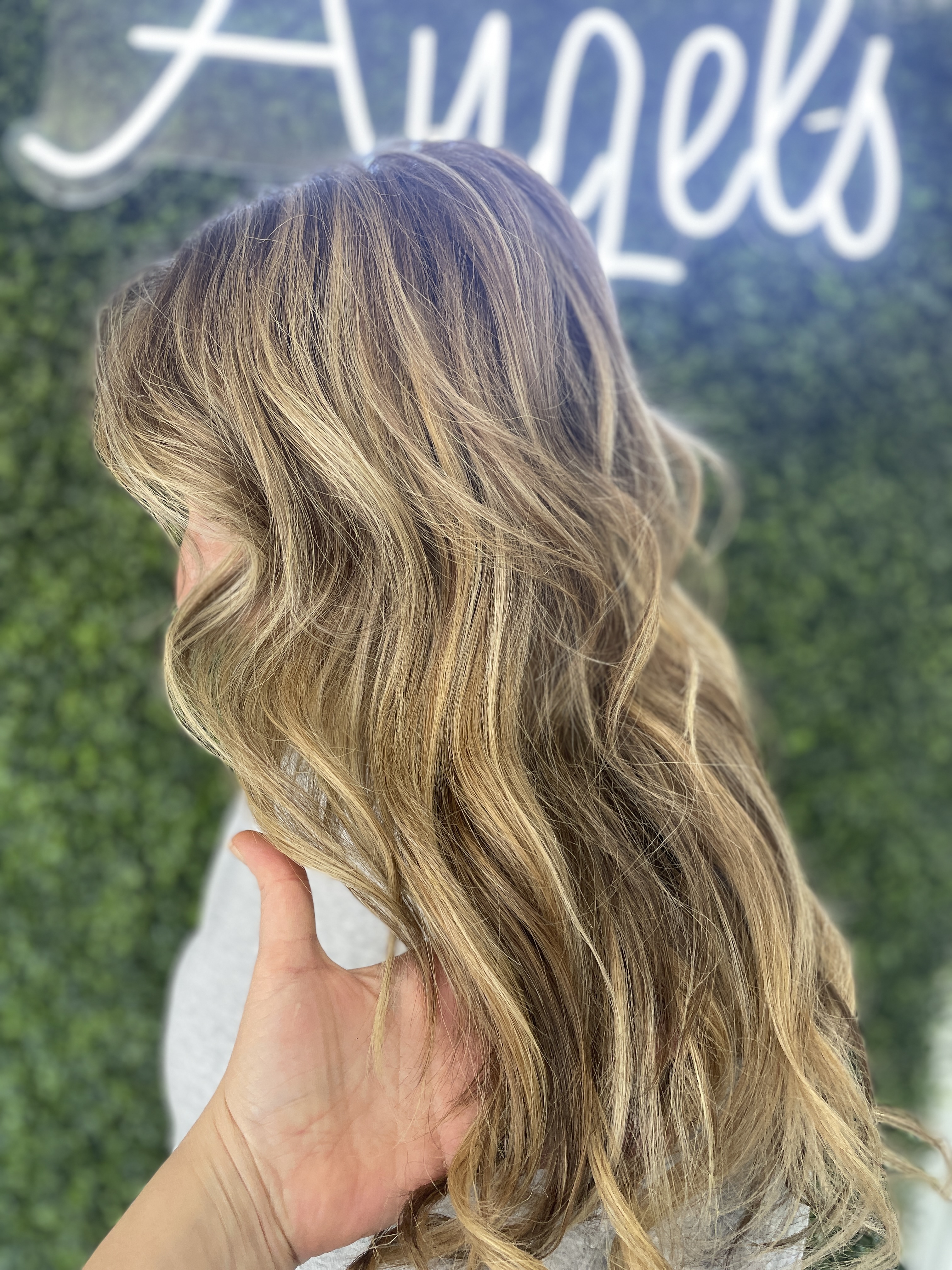 a picture of sew-in weft hair extensions on highlighted blonde hair