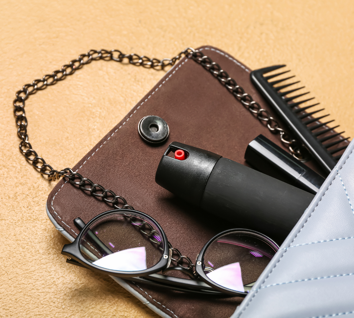 grey bag with pepper spray and accessories