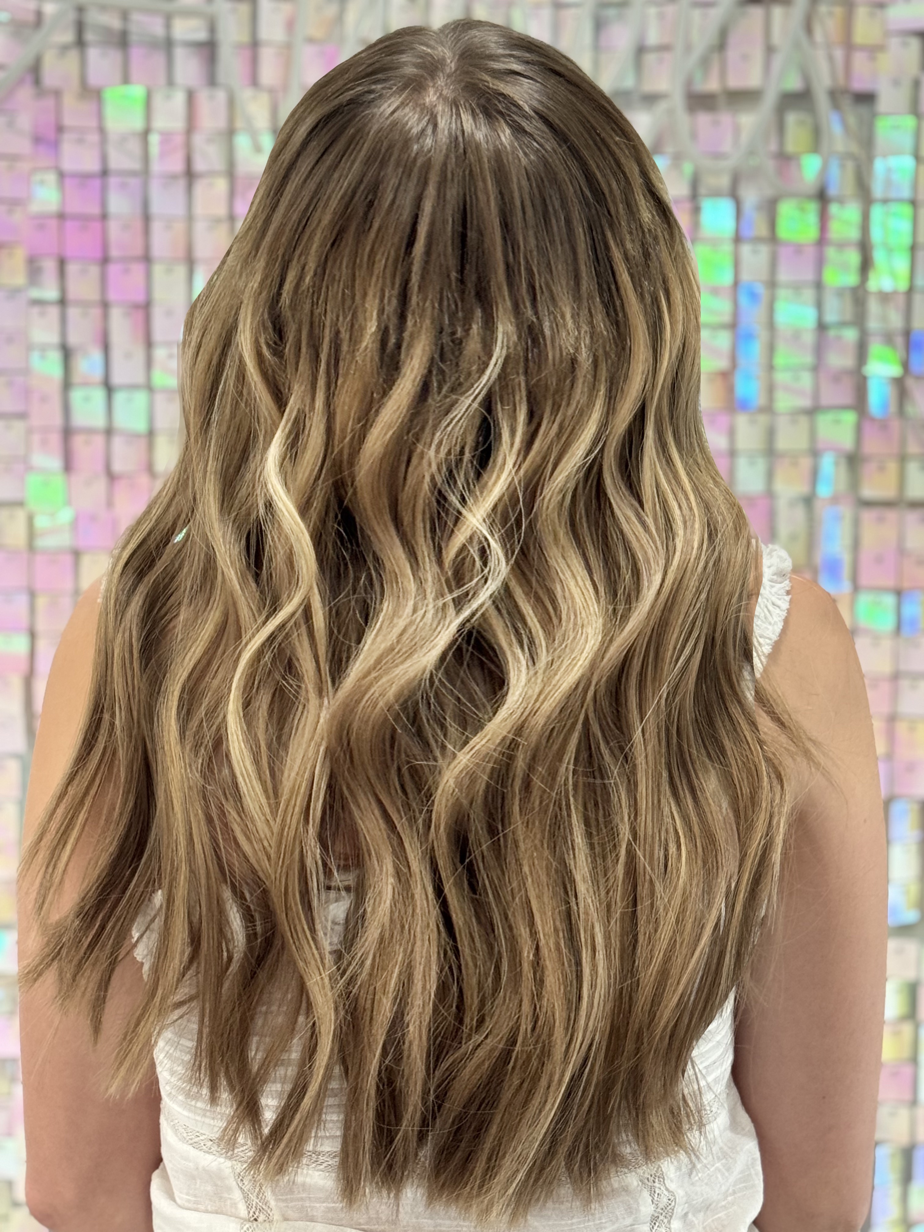 a woman wearing a wavy hand tied wig