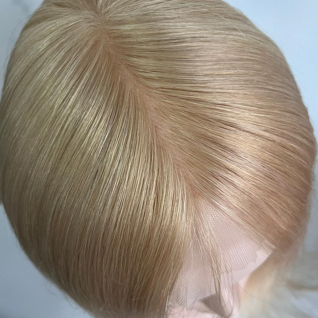 a closeup photo of a mini hair topper with bangs