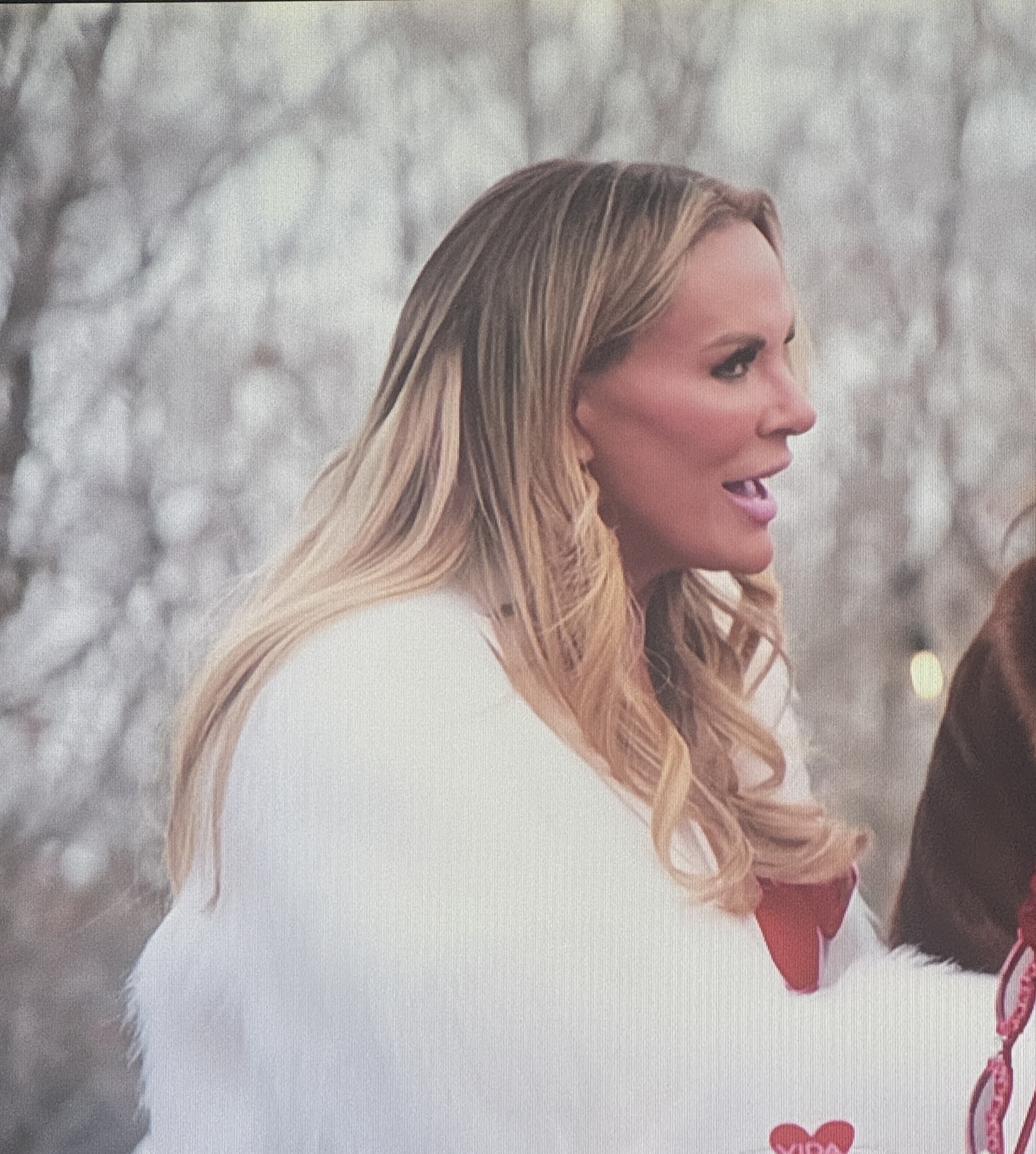 A reality star with visible hair extensions