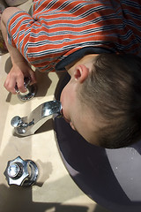 Image showing Little Boy Drinking Water from the Faucet