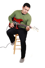 Image showing Man sitting with guitar.