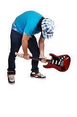 Image showing Boy mad at the guitar.