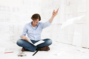 Image showing Engineer checking drawings