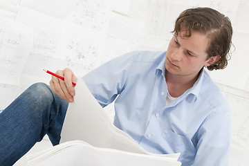 Image showing pn[5DNYS6S] Mechanical engineer checking drawings