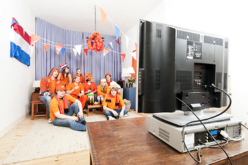 Image showing Watching the game at home