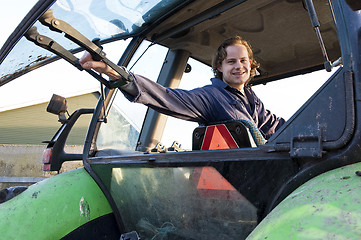 Image showing Farm hand in a tractor