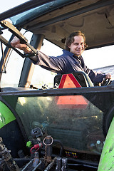 Image showing Farm hand in a tractor