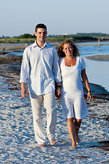 Image showing Young couple walking on beach