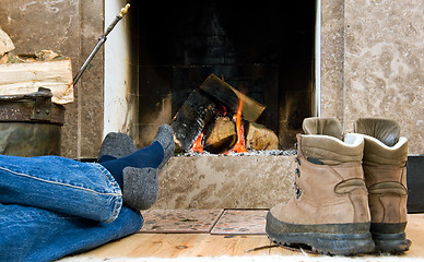 Image showing Hiker resting by the fireplace