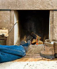 Image showing Hiker resting by the fireplace