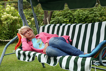 Image showing young woman resting in a garden chair. (shaker)