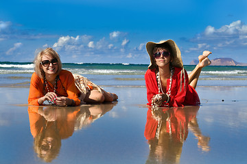 Image showing beautiful woman lays on beach