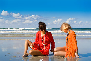 Image showing two beautiful women sitting on beach