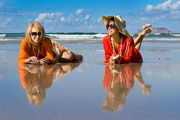 Image showing beautiful woman lays on beach