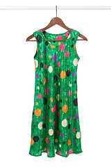 Image showing Bright green dress on a wooden hanger