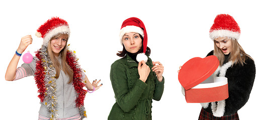 Image showing Three girls in cristmas hat with gift