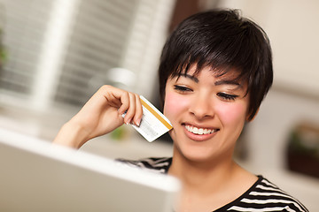 Image showing Smiling Multiethnic Woman Holding Credit Card Using Laptop