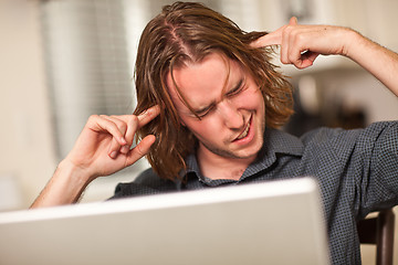 Image showing Young Man Getting Loopy While Using Laptop Computer