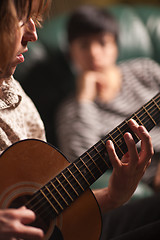 Image showing Young Musician Plays His Acoustic Guitar as Friend Listens