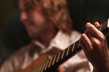 Image showing Young Musician Plays His Acoustic Guitar