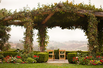 Image showing Vine Covered Patio and Chairs with Country View