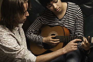 Image showing Young Musician Teaches Female Student To Play the Guitar