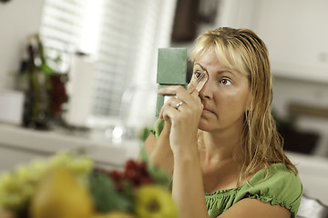 Image showing Blonde Woman Applying Her Makeup