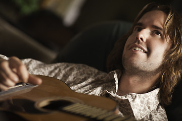 Image showing Young Musician Plays His Acoustic Guitar