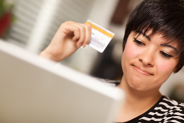 Image showing Smiling Multiethnic Woman Holding Credit Card Using Laptop