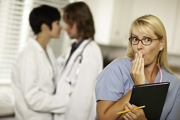 Image showing Alarmed Medical Woman Witnesses Colleagues Inner Office Romance.
