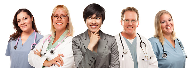 Image showing Young Multiethnic Woman with Doctors and Nurses Behind