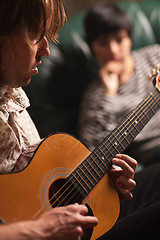 Image showing Young Musician Plays His Acoustic Guitar as Friend Listens