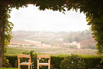 Image showing Vine Covered Patio and Chairs Overlooking the Country