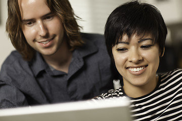 Image showing Happy Young Man and Woman Using Laptop Together