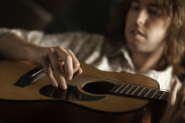 Image showing Young Musician Plays His Acoustic Guitar