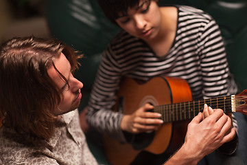 Image showing Young Musician Teaches Female Student To Play the Guitar