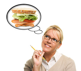 Image showing Hungry Woman with Thought Bubbles of Big, Fresh Sandwich